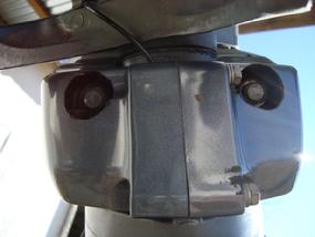 Cut 1" diameter holes in the plastic cowling to access the bolt heads